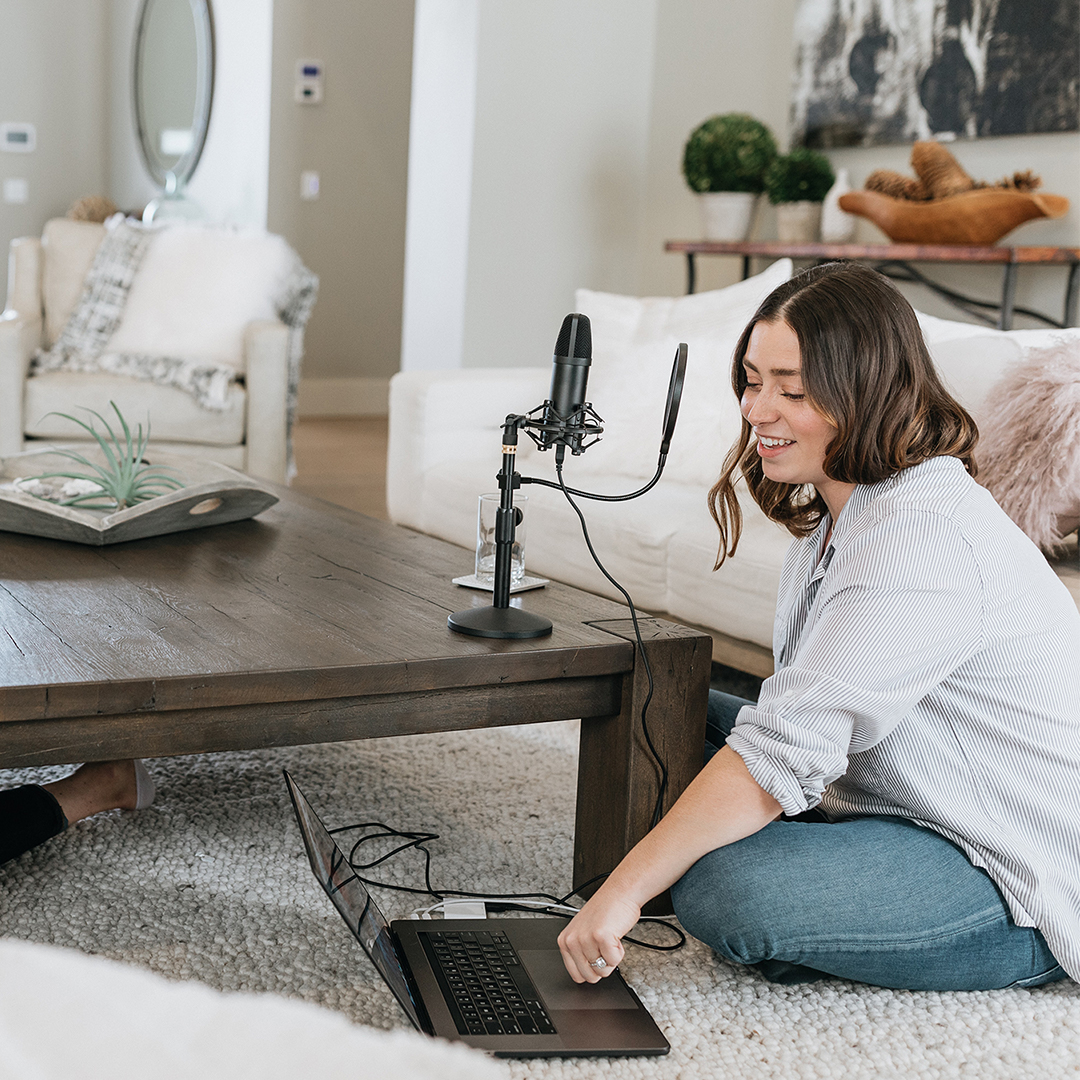 Image of two female entrepreneurs recording a podcast in their living room